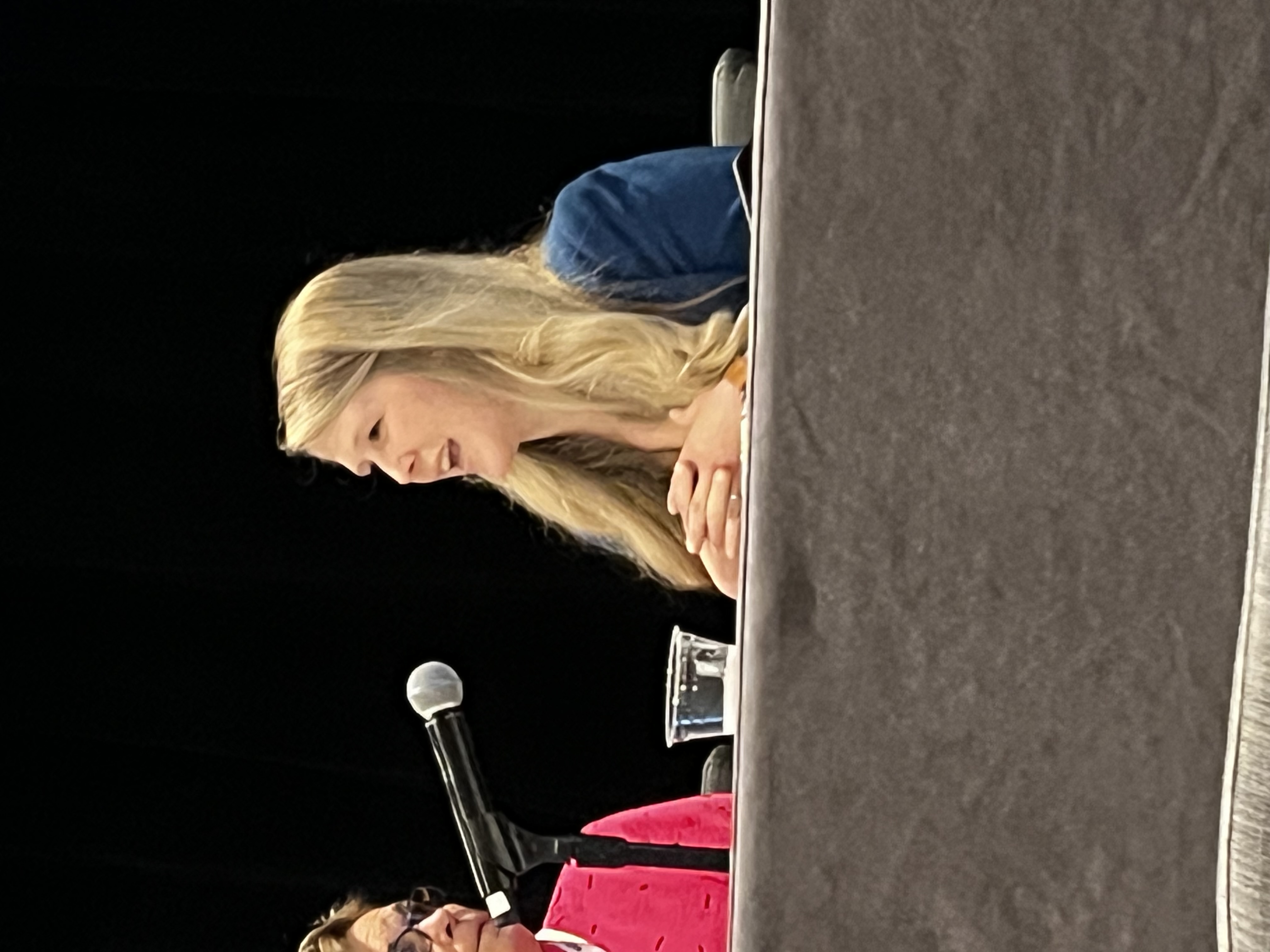 Jessica Winchester publicly speaking in front of a microphone